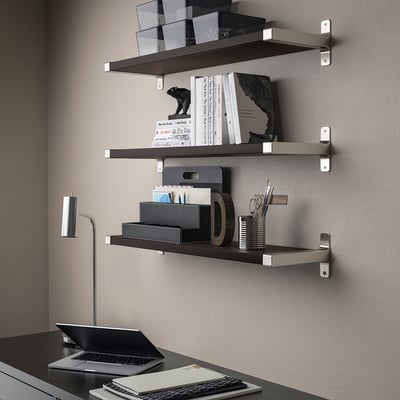 Modern workspace with adjustable shelves, a laptop, keyboard, and desk lamp.
