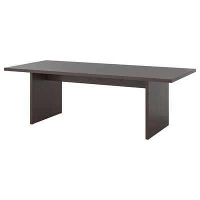 Depicts a dark brown BERGSHYTTAN dining table with a rectangular top and sturdy legs. The table a smooth, wooden finish and a minimalist design.