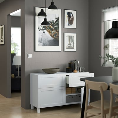 Modern living room with white sideboard, lamps.