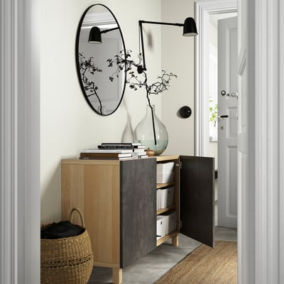 Sideboard combo with adjustable shelves, soft-closing doors, and storage boxes. A large mirror and wall lamp above.