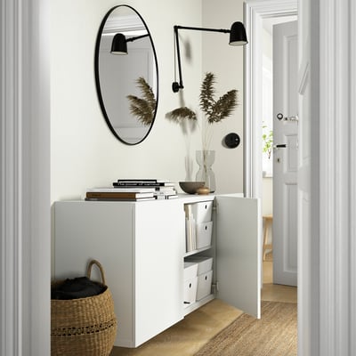 Modern hall with BESTÅ storage, mirror, lamps, wicker basket.