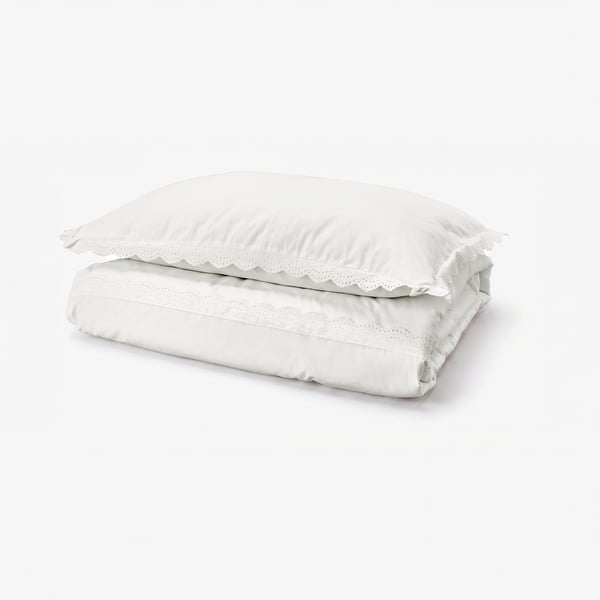 White folded duvet cover with lace trim, 100% cotton.