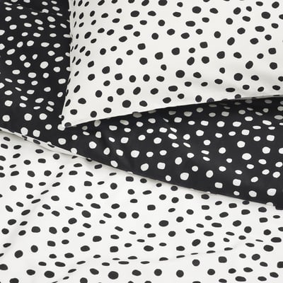 Black and white polka dot bedding set, soft cotton-viscose blend, neatly folded.