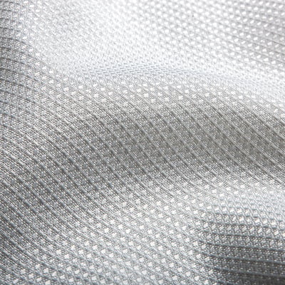 Close-up of textured, water-repellent polyester fabric with a waffle pattern.
