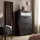 Modern room with black BRIMNES chest, 4 drawers, gold lamp, plant.