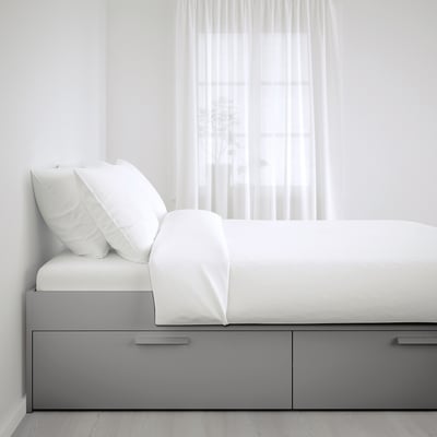 BRIMNES white bed with grey drawers, elevated design, compact for small spaces.