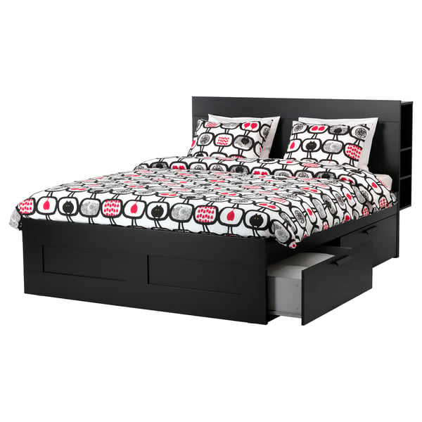 An IKEA BRIMNES bed in black with built-in storage drawers and a headboard, featuring a white and red patterned duvet cover.