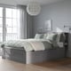 Grey BRIMNES bed with storage, pendant lamp, and bookshelf.