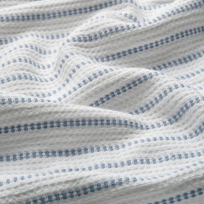 White cotton towel with blue stripes, waffle texture for grip, soft terry side.