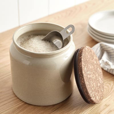 Beige stoneware jar with cork lid & stainless steel scoop for dry goods like rice.