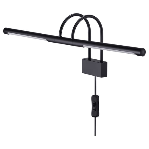 A BRYNET black wall lamp with a sleek, adjustable design. The lamp a metal tube and a directional light for highlighting items.