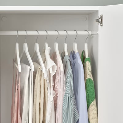 Closet with hangers holding various clothing items, keeping the wardrobe neat and organised.