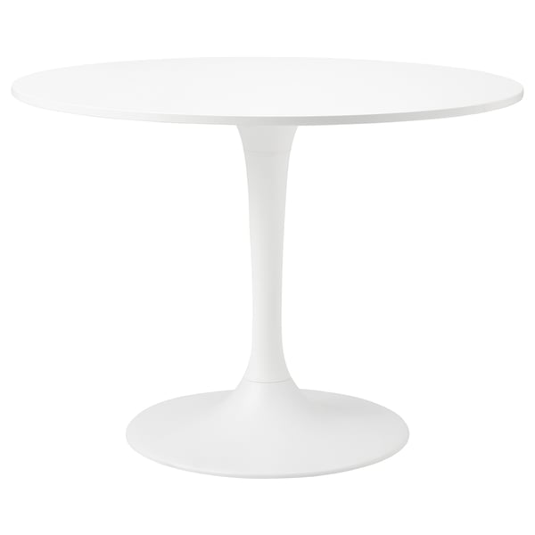 Displays a white round table with a single supporting column, reflecting a modern and minimalist design.