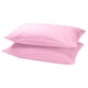 Two soft pink rectangular pillows stacked neatly, smooth and simple design.