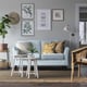 Cosy living room with blue EKHOLMA sofa, cushions, patterned pillows, art wall, rug, plant side table, wicker chair.