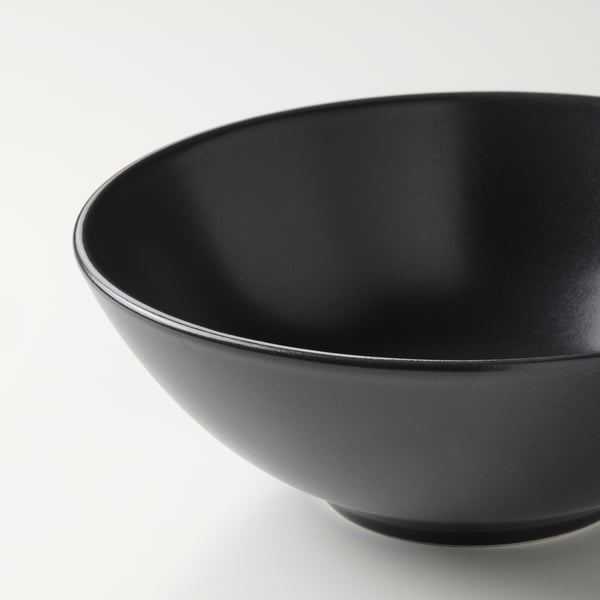 Sleek matte black bowl, smooth rim, sturdy stoneware quality, perfect for serving.