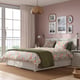 FÅGELFJÄLLET floral bed in cosy bedroom with storage, large window, pink walls.