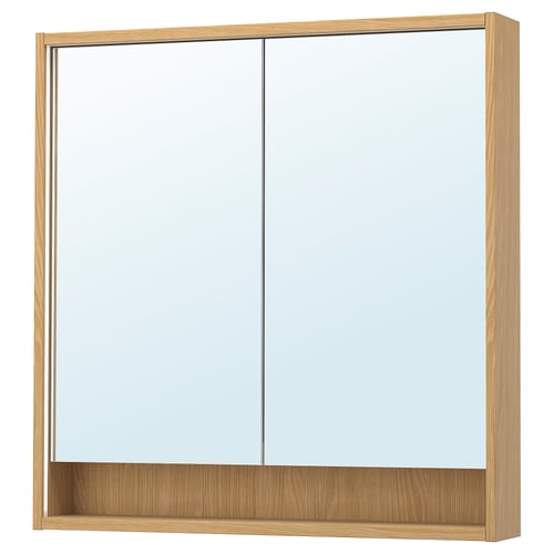 The FAXÄLVEN mirror cabinet, in light oak, integrated lighting and a shelf for storage.