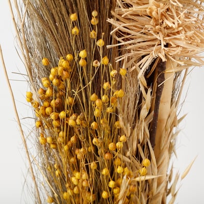 Dried plant arrangement with yellow buds, natural texture, fresh-looking.