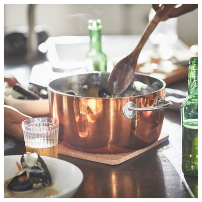Cooking seafood on stove with beer nearby