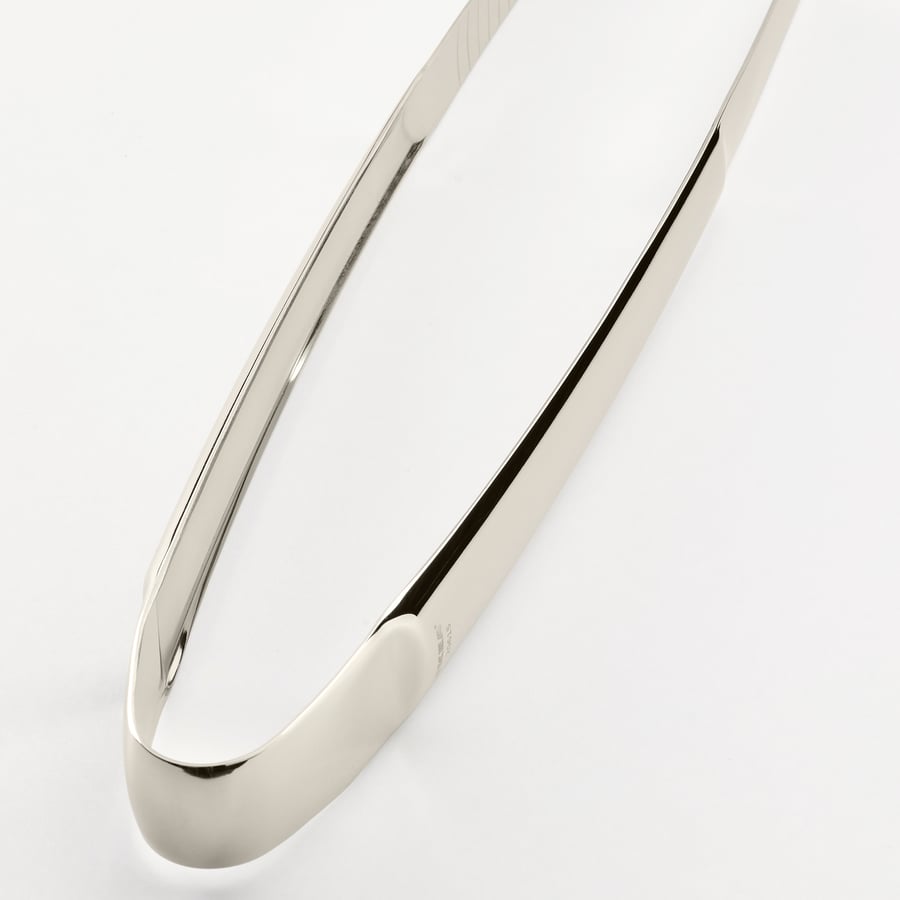 Stainless steel cooking tweezers, sleek and polished, shown open against white background.