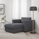 Modern cosy corner: dark grey FINNALA sectional sofa with ottoman, plus tall floor lamp. Comfortable & stylish, fits neatly in space.