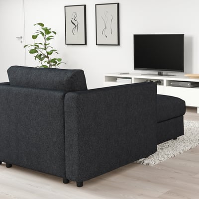 Dark grey FINNALA sectional sofa, modern & modular, fits well in spacious living room with wooden floors and white walls.