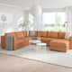 Modern living room with orange-brown FINNALA sectional sofa-bed, white wire coffee table, and minimalist decor.