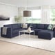 Modern living room with blue FINNALA sectional, white coffee table, large windows.