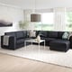 Modern living room with FINNALA grey sectional couch, white coffee table, large window, and stylish decor.