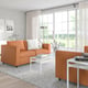 Modern living room with FINNALA orange sectional sofa, white coffee table, large window, and minimalist decor.