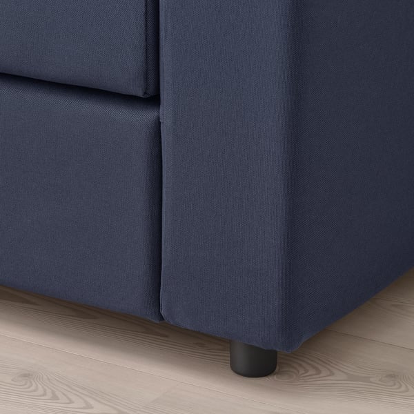 Dark blue sectional sofa with clean design and comfortable cushions on wooden floor.