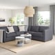 Modern living room with FINNALA sectional sofa, coffee table, side table, rug, and large window with curtains and pendant light.