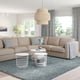 FINNALA beige sectional sofa, wire tables, large window, blue rug.