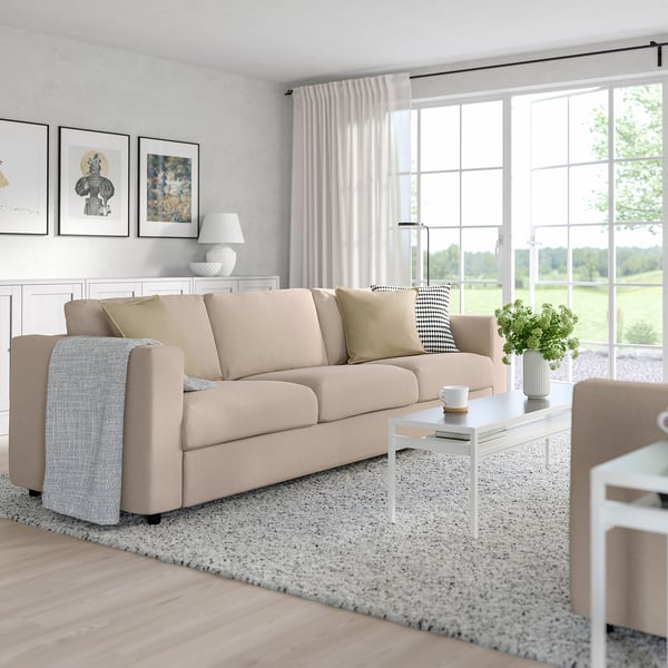 Modern living room with FINNALA sectional sofa, armchairs, coffee table, and decor.