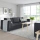 Modern living room with FINNALA sectional sofa, coffee table, and three framed pictures.