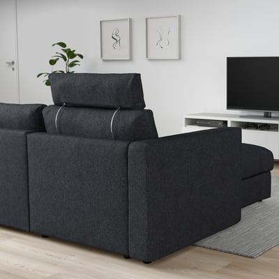 FINNALA sectional sofa, dark grey, with foam and polyester. Its large, fitting a tv and plant, plush with adjustable headrests.