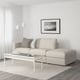 Minimalist living room with FINNALA sectional sofa, coffee table, floor lamp, and coastal art.