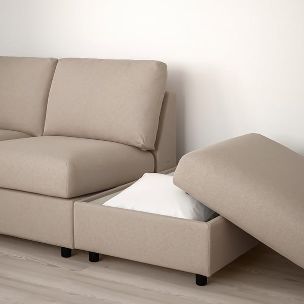 This image shows a modular sofa with a footstool featuring a built-in storage compartment.