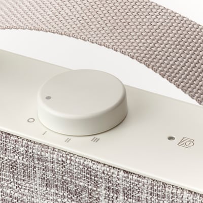 Close-up of modern air purifier control panel with fabric cover.