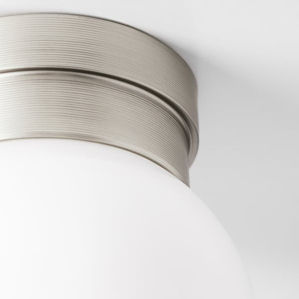 Close-up of metallic lamp shade with smooth curves.