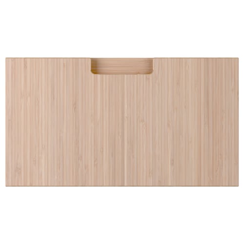 A rectangular wooden drawer front in natural bamboo colour with integrated handles.