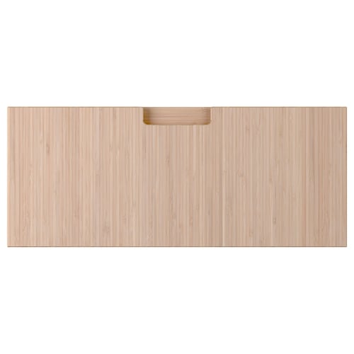 Depicts a light-colored wooden drawer front with a handle. It is made of bamboo, featuring a clean, modern design.