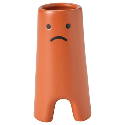 FRÖVÄXT orange vase, frowning face design, cylindrical shape, stoneware material.