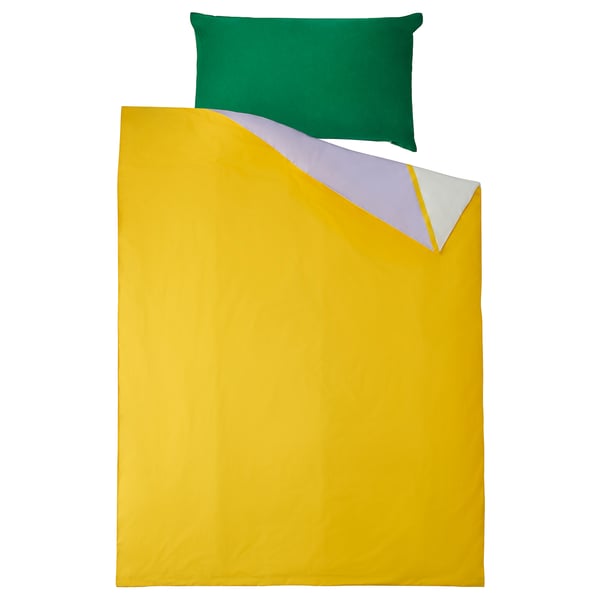 Bright yellow bedding set with green pillow, modern design.