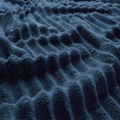 Plush, textured dark blue fleece blanket, soft and inviting.
