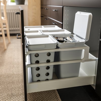 Organised kitchen drawer with HÅLLBAR bins. Grey bins hold utensils, small items, and recyclables. White cover lid.