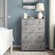 HAUGA grey chest with 4 drawers, small lamp, vases, near white bed in blue room.