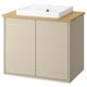 A HAVBÄCK bathroom cabinet in beige with a bamboo countertop and a white ceramic sink. Modern and functional design.