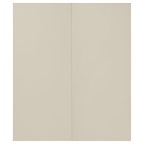 A pair of beige HAVSTORP cabinet doors. These smooth, rectangular, lacquered doors feature clean lines and a modern design.
